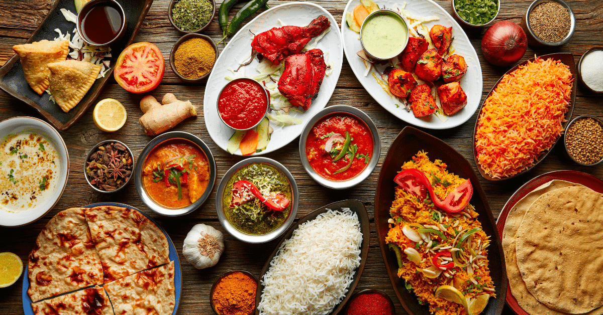 A colorful Indian spice market showcasing an array of spices and herbs.