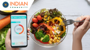 A person holding a smartphone displaying a daily calorie tracker showing 1200 calories, while using a fork to eat a healthy salad