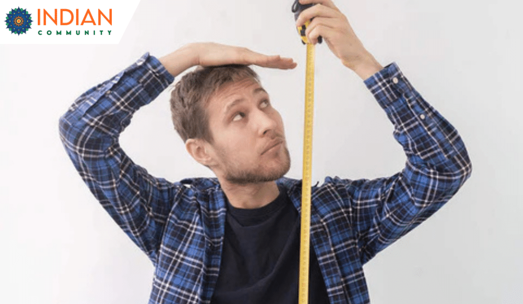 A guy ,measuring his height with measuring tape