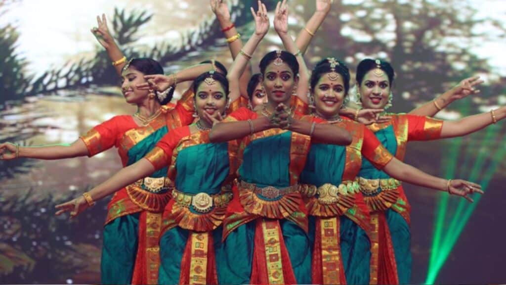 raditional Bharatanatyam dancers in colorful attire performing gracefully