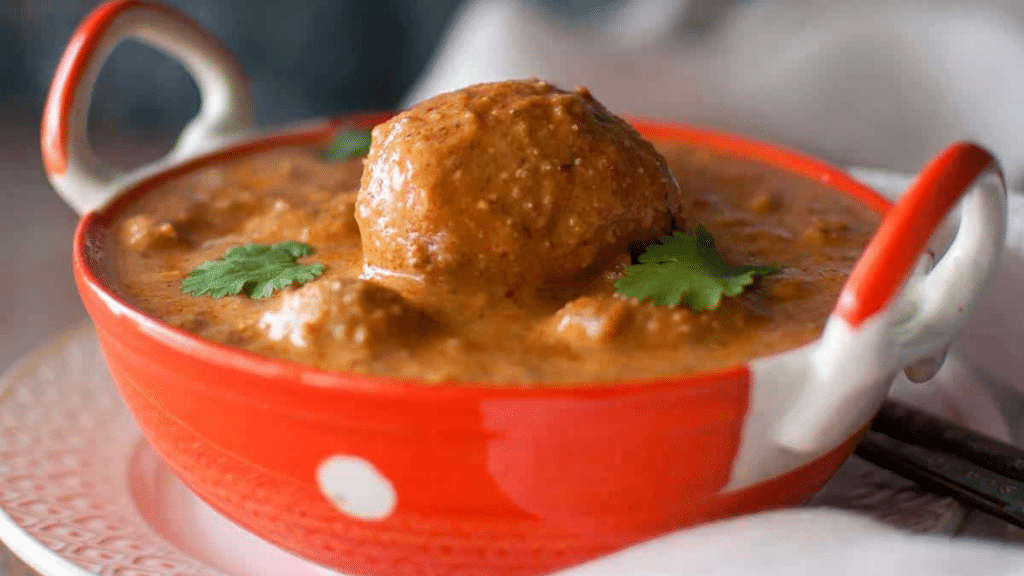 Golden fried baby potatoes in rich tomato-based gravy.