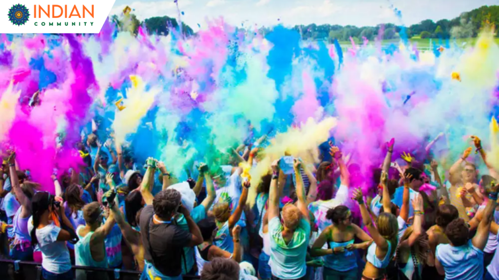 People celebrating Holi festival with bright colors and joyful dances in New York City.