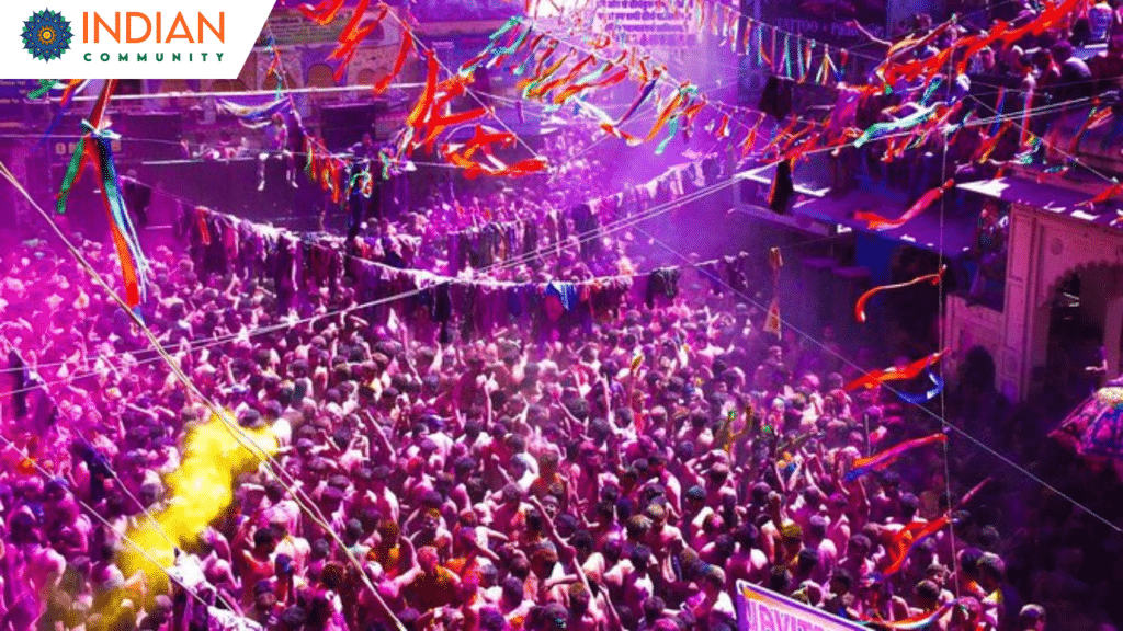 "People celebrating Holi in Pushkar with vibrant colors, electronic music, and traditional rituals, captured from above the rooftops of the town.