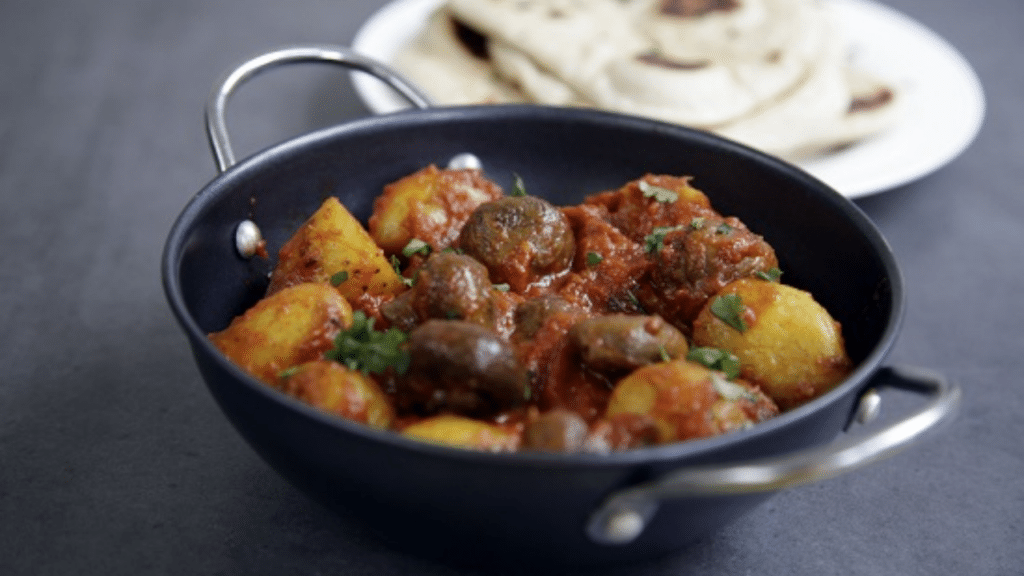 Aloo Mushroom Curry served with steamed rice, garnished with cilantro